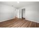 Clean, bright bedroom with wood-look flooring, closet and entrance to a another room at 7571 Ridge Rd, Seminole, FL 33772