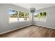 Bright dining area with windows, a stylish chandelier, and wood flooring at 7571 Ridge Rd, Seminole, FL 33772