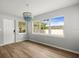 Dining room features hardwood floors, bead chandelier and natural light at 7571 Ridge Rd, Seminole, FL 33772
