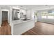 Contemporary kitchen with stainless steel appliances, bright white cabinets, a center island, and an eat-in bar at 7571 Ridge Rd, Seminole, FL 33772