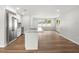 Well-lit kitchen with hardwood floors, stainless steel appliances, and an island at 7571 Ridge Rd, Seminole, FL 33772