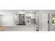Bright, open kitchen with white cabinets, stainless steel appliances, granite countertop, and breakfast bar seating at 7571 Ridge Rd, Seminole, FL 33772