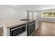 Modern kitchen with stainless steel appliances and center island cooktop at 7571 Ridge Rd, Seminole, FL 33772