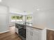 Modern kitchen features an island with cooktop and stainless steel appliances at 7571 Ridge Rd, Seminole, FL 33772