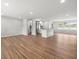 Bright, open-concept living room with gleaming hardwood floors, neutral paint, and plenty of natural light at 7571 Ridge Rd, Seminole, FL 33772