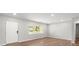 Spacious living room with a large window, hardwood floors, and freshly painted walls at 7571 Ridge Rd, Seminole, FL 33772
