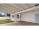 Covered patio with wood-look flooring and white-painted roof at 7571 Ridge Rd, Seminole, FL 33772