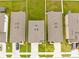 Aerial view of rooftops in a residential area with green lawns and driveways between neighboring homes at 81 Rain Lily Ave, Spring Hill, FL 34609