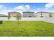 Well-maintained backyard with a white vinyl fence, offering privacy and a secure space for outdoor activities at 81 Rain Lily Ave, Spring Hill, FL 34609