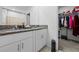 Bathroom with dual sinks, granite countertop and walk-in closet at 81 Rain Lily Ave, Spring Hill, FL 34609