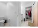 Bathroom with a toilet, walk-in closet and a tiled floor at 81 Rain Lily Ave, Spring Hill, FL 34609