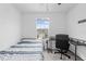 Bright bedroom features a ceiling fan, a bed, and a desk with a chair next to the window at 81 Rain Lily Ave, Spring Hill, FL 34609