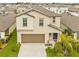 Aerial shot of two-story home with a two car garage, neatly manicured lawn at 81 Rain Lily Ave, Spring Hill, FL 34609
