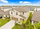 Two-story home with a well-manicured lawn and two-car garage at 81 Rain Lily Ave, Spring Hill, FL 34609