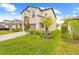 Charming two-story home with lush landscaping and a well-manicured lawn at 81 Rain Lily Ave, Spring Hill, FL 34609