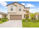 Charming two-story home with a well-manicured lawn, two-car garage, and a welcoming facade at 81 Rain Lily Ave, Spring Hill, FL 34609