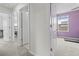 Hallway view into rooms with carpet flooring and neutral paint, doors and trim are white at 81 Rain Lily Ave, Spring Hill, FL 34609