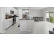 Open kitchen with stainless appliances and a dining area with sliding glass doors at 81 Rain Lily Ave, Spring Hill, FL 34609