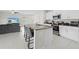 Open concept kitchen with an island and a cozy living room at 81 Rain Lily Ave, Spring Hill, FL 34609
