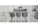 Kitchen island with granite countertop and seating provides a stylish gathering spot at 81 Rain Lily Ave, Spring Hill, FL 34609