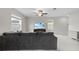 Bright living room featuring a large sectional sofa and a ceiling fan at 81 Rain Lily Ave, Spring Hill, FL 34609