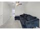 Upstairs living area with a comfortable sectional sofa and ceiling fan at 81 Rain Lily Ave, Spring Hill, FL 34609
