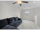 Spacious upstairs living area featuring a comfy sectional, ceiling fan, and bright window at 81 Rain Lily Ave, Spring Hill, FL 34609