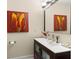 Modern powder room with decorative painting, elegant faucet, and tasteful decor at 829 Date Palm Ln, St Petersburg, FL 33707