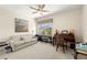 Multi-purpose room with a sofa, a desk, piano and art, illuminated by natural light at 829 Date Palm Ln, St Petersburg, FL 33707