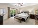 Comfortable main bedroom with a cozy bed, dark furniture, and balcony access at 829 Date Palm Ln, St Petersburg, FL 33707