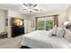 Bright bedroom with TV, balcony access, and neutral color scheme creating a cozy retreat at 829 Date Palm Ln, St Petersburg, FL 33707