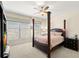 Cozy bedroom with four poster bed, ceiling fan, large windows and neutral décor at 829 Date Palm Ln, St Petersburg, FL 33707