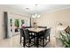 Elegant dining room with seating for six and a view of the outdoor patio at 829 Date Palm Ln, St Petersburg, FL 33707