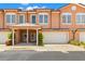 Charming townhouse with a two-car garage and lovely landscaping under a bright blue sky at 829 Date Palm Ln, St Petersburg, FL 33707