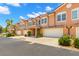 Townhouses featuring two-car garages, tiled roofs, and manicured lawns, perfect for comfortable living at 829 Date Palm Ln, St Petersburg, FL 33707