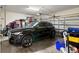 Spacious two car garage with overhead storage and a black SUV parked inside at 829 Date Palm Ln, St Petersburg, FL 33707