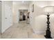 Well-lit hallway with tile flooring, leading to various rooms, enhanced by stylish decorations at 829 Date Palm Ln, St Petersburg, FL 33707