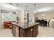 Open kitchen with granite countertops, stainless steel wine cooler, tile floors, and adjacent dining area at 829 Date Palm Ln, St Petersburg, FL 33707