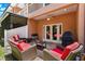 Inviting outdoor patio with comfortable seating, grill, and access to the interior through French doors at 829 Date Palm Ln, St Petersburg, FL 33707