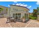 View of community pool house featuring awnings, outdoor seating and well maintained landscaping at 829 Date Palm Ln, St Petersburg, FL 33707