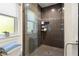 Modern shower with glass door, mosaic tile accent, built in niche and large window for natural light at 829 Date Palm Ln, St Petersburg, FL 33707