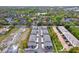 A high angle aerial view of townhouse apartments, with parking in front of each and wooded areas in the background at 8714 Palm Ranches Pl, Tampa, FL 33614