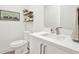 Modern half-bathroom featuring a floating vanity, contemporary decor, and clean, white finishes at 8714 Palm Ranches Pl, Tampa, FL 33614