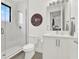 Modern bathroom with glass shower, toilet, sleek vanity, and a decorative Georgia Bulldogs wall plaque at 8714 Palm Ranches Pl, Tampa, FL 33614