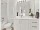 Bathroom featuring a shower-tub combo, a white vanity, chrome fixtures, and a framed print at 8714 Palm Ranches Pl, Tampa, FL 33614