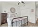 The bedroom showcases an iron bed frame, wood floors, closet, a mirror, and a dark wood chest of drawers at 8714 Palm Ranches Pl, Tampa, FL 33614