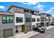 Modern townhomes showcasing gray and white exterior with individual garages, offering stylish urban living at 8714 Palm Ranches Pl, Tampa, FL 33614