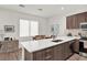 Bright kitchen with a center island, wooden cabinetry, and a dining area with natural light at 8714 Palm Ranches Pl, Tampa, FL 33614