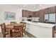 Well-lit kitchen featuring stainless steel appliances, an island with bar seating, and a dining area at 8714 Palm Ranches Pl, Tampa, FL 33614