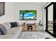Modern living room boasting comfortable seating, a large screen television, and a sliding glass door at 8714 Palm Ranches Pl, Tampa, FL 33614